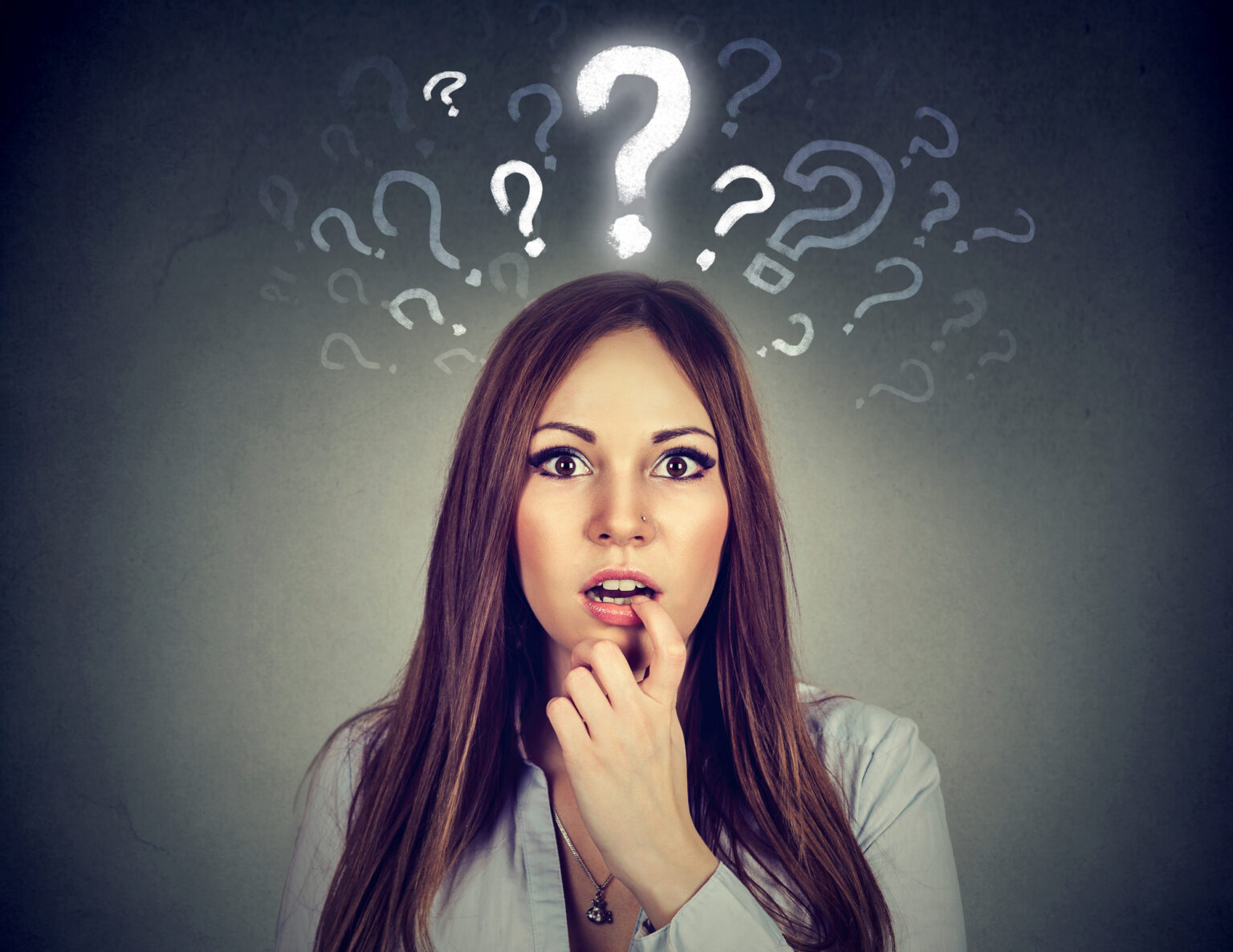 Surprised amazed young woman with many questions and no explanation or answer