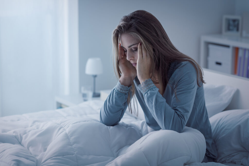 Depressed woman awake in the night she is exhausted and suffering from insomnia